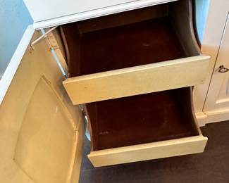 Pull out drawers. The middle top drawer is for a silverware set. Custom interior.