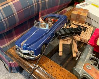 Vintage Arnold Tin Toy remote controlled sedar convertible with man driver and woman passenger. 