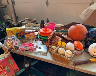 Vintage sports equipment, including tennis raquets and heavy duty horseshoes 