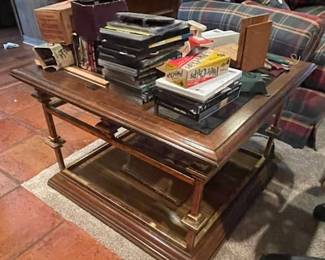 Mid century modern glass top coffee table with decorative gold flecked metal base.