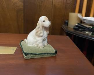 Vintage Hallmark Spaniel figurine on velvet pillow.