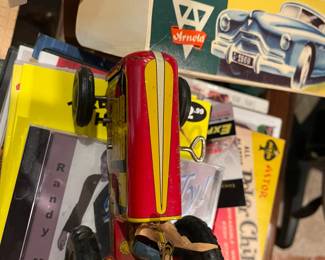 Vintage Arnold Tin Toy remote controlled sedar convertible with man driver and woman passenger. 
