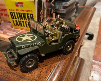 Vintage WWII toy jeep 002100 with passengers.