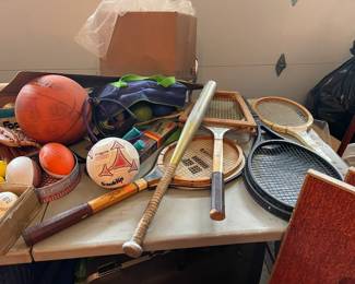 Vintage sports equipment, including tennis raquets and heavy duty horseshoes 