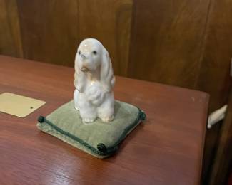 Vintage Hallmark Spaniel figurine on velvet pillow.