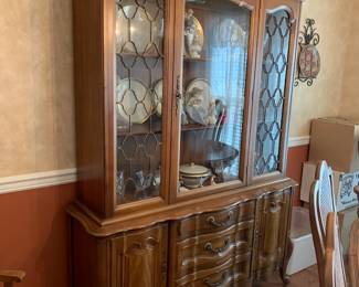 #8	French Provinil Dining Room Table w/2 leaves. 8 Cane Back Upholstered Chairs. (2 captains chair) 58-83x41x29	 $300.00 
#9	French Provincial China Cabinet - Lighted. 3 Drawers, 2 wood doors, 1 glass door. 56x16x29-80 (1 piece)	 $175.00 
