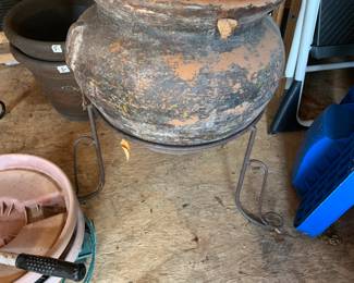 #87	ceramic pot with case iron base 23 tall 	 $75.00 
