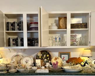 Large counter full of vintage and antique porcelain, plasticware.  Tons of napkins.