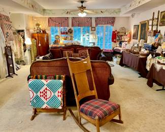Large game room full of linens, porcelain, quilts, and Christmas!