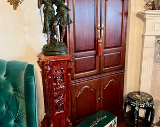 TV cabinet with flatscreen inside.  Notice the statue!
