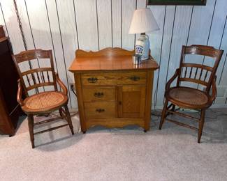 PAIR OF WALNUT CARVED ARM CHAIRS WITH CANED SEATS AND AN ANTIQUE DRY SINK 