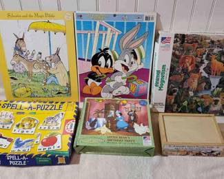 (6) Puzzle Sets Including Looney Tunes, Little Bear, And William Steig
Puzzles include - Looney Tunes,  Sylvester and the Magic Pebble by William Steig, Little Bear Birthday Party Puzzle by Maurice Sendak (18" by 24"), Animal Magnetism (20x27 inches), Spell A Puzzle (21) mini puzzles), and Jigsaw in a Box by Melissa & Doug (4 compartmented puzzles). 