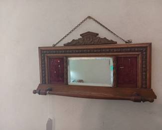 Antique shaving mirror with towel bar.