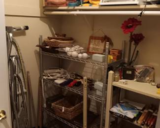 Ironing board,  shelves and small kitchen appliances. 