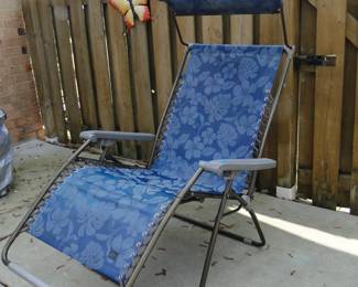 Relax and unwind in this canopy covered zero gravity chair