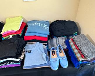 Variety of women's shorts, pants, leggings, shirts, shoes. Clothes are size Large -ish. Shoes are size 8.5-9.5