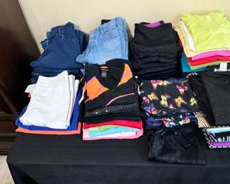 Variety of women's shorts, pants, leggings, shirts, shoes. Clothes are size Large -ish. Shoes are size 8.5-9.5