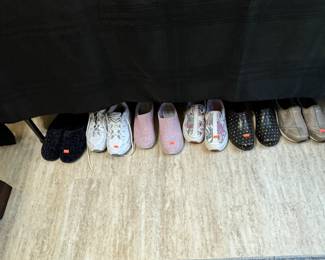 Variety of women's shorts, pants, leggings, shirts, shoes. Clothes are size Large -ish. Shoes are size 8.5-9.5