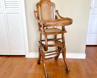 VINTAGE HIGH CHAIR CANE SEAT AND BACK ON METAL WHEELS - CONVERTS TO A ROCKER
