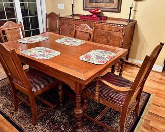 Tiger maple dining table with matching buffet/sideboard in background.