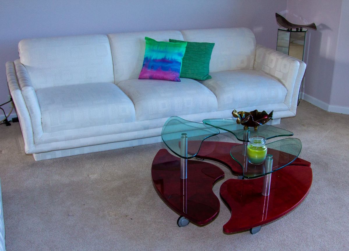 Upholstered couch, glass top coffee table