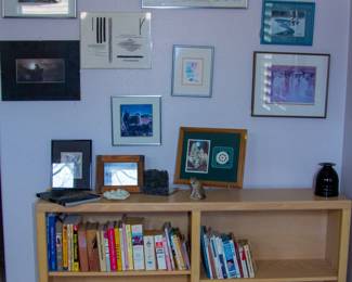 Various artwork, small wooden bookshelf and books