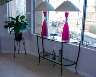 Glass top table with pink lamps