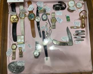 men's watches, knives, buckle, and one giant pacifier