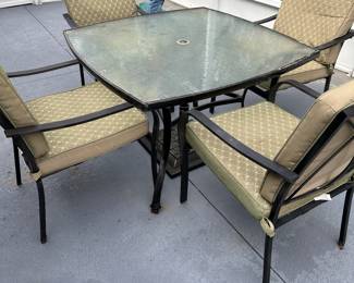 Patio table with four chairs and an umbrella