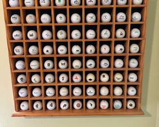 Assorted golf balls from different courses 