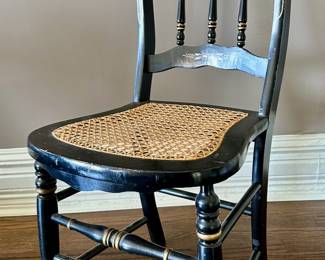 Black and gold cane bottom Hitchcock chair.