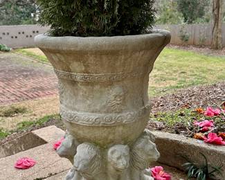 One of a pair of concrete lions planters.