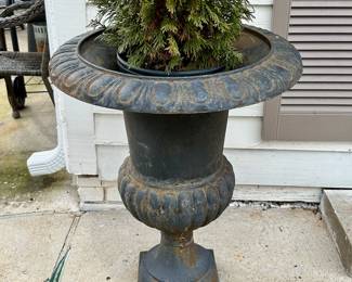 One of an available pair of black metal urns.