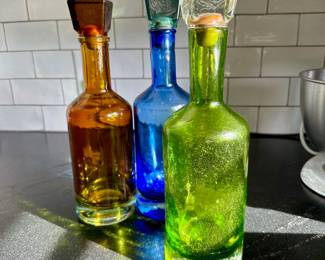 Colorful Mexican glass bottles with stoppers.
