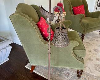 Deco-era bronze griffin floor standing lamp.  Two available.  Olive green wing back chairs by Hickory and White.