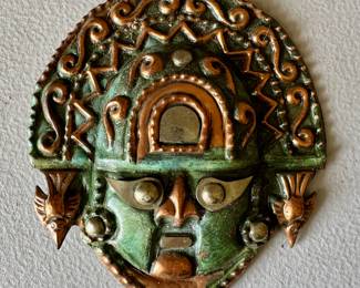 Copper Aztec mask wall decor.