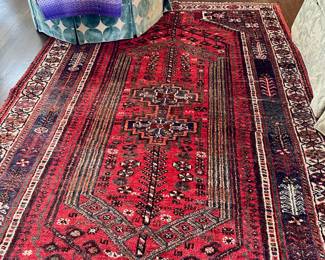 Wool persian rug and round ottoman.