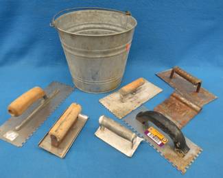Lot 87. Trowels and an edger in a galvanized pail