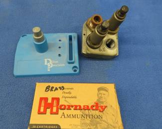 Lot 53. Dillon tool head with 6.5/284 WIN dies, a stand, and 19 pieces of 6.5 Grendel brass