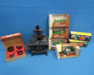 Lot 330. Greycraft Cast Pots & Pans, Crescent Cast-iron Stove, Three 1/43 Ertl Manure Spreaders, Two Ertl Fou