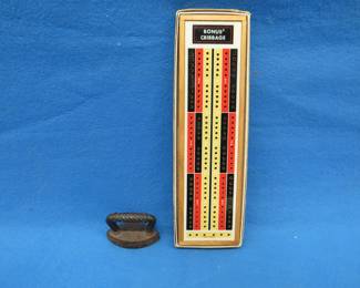 Lot 203. Antique cast-iron miniature sad iron and a cribbage board