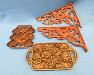 Lot 353. Cast iron including a John Wright muffin tin, candy mold, and a pair of angel-themed shelf brackets