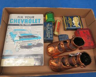 Lot 367. Vintage tins, bronzed baby shoes, and a Fix Your Chevrolet book