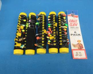 Lot 382. Five Tackle Tamers with jigs in a Rubbermaid container