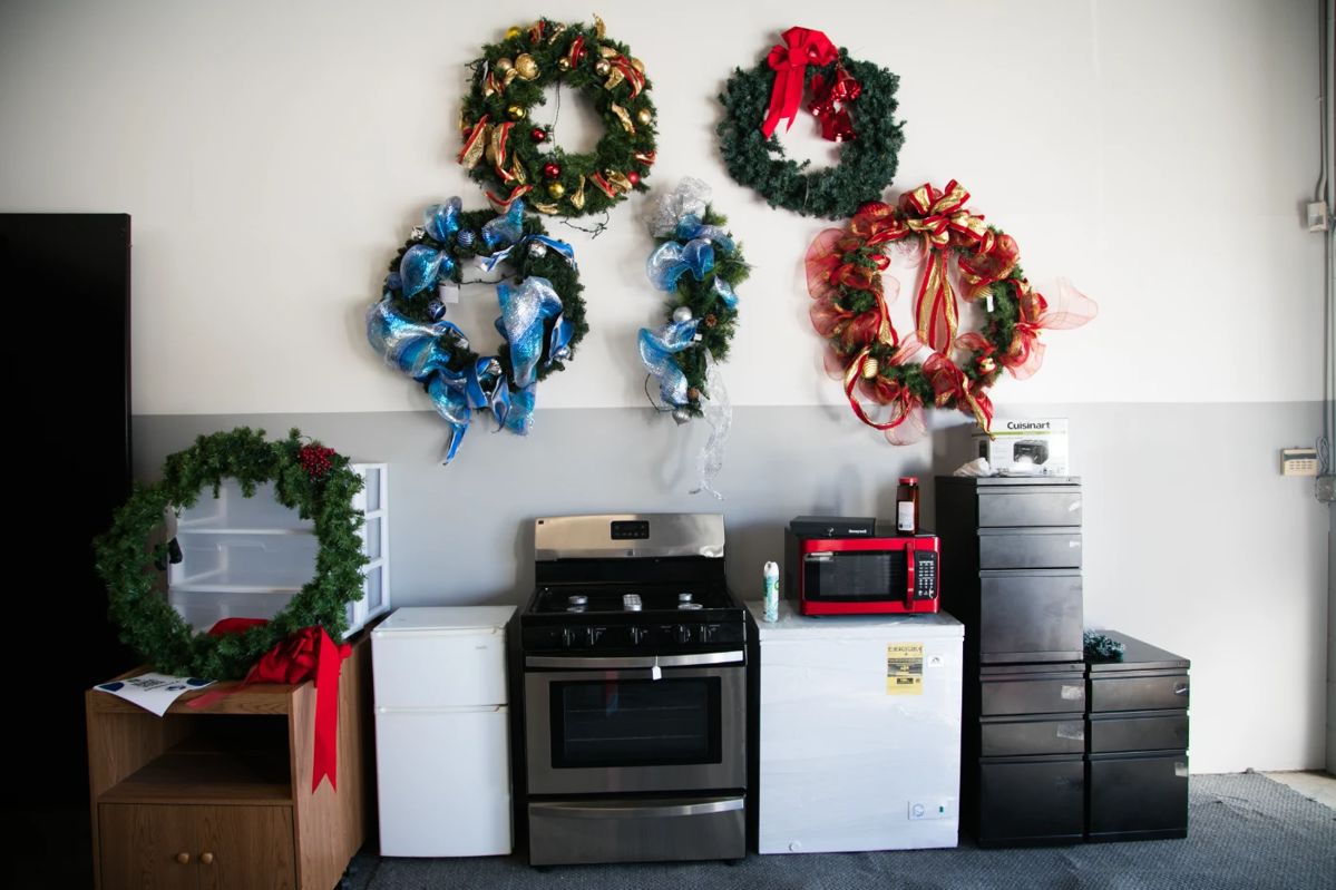 Stove, mini fridge, microwave, file cabinets, wreaths