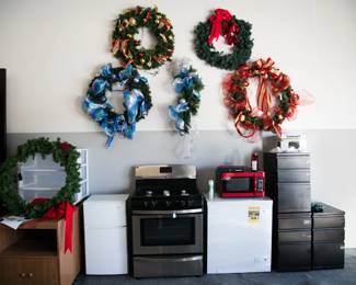 Stove, mini fridge, microwave, file cabinets, wreaths