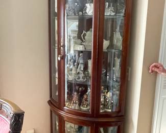 . . . curved-glass curio cabinet stuffed with treasures