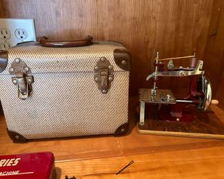 	#62	Red hand sewing machine with case	 $75.00 				