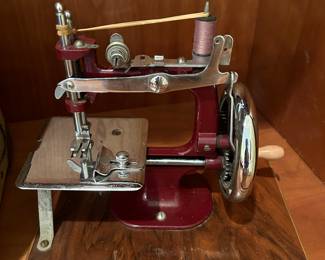 	#62	Red hand sewing machine with case	 $75.00 				
