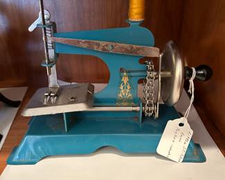 	#67	Blue "Little Stitcher" hand sewing machine	 $20.00 				